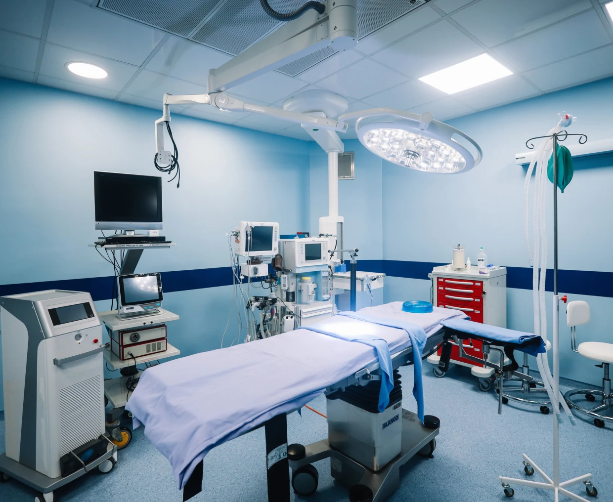 Surgical room with blue lighting and tools